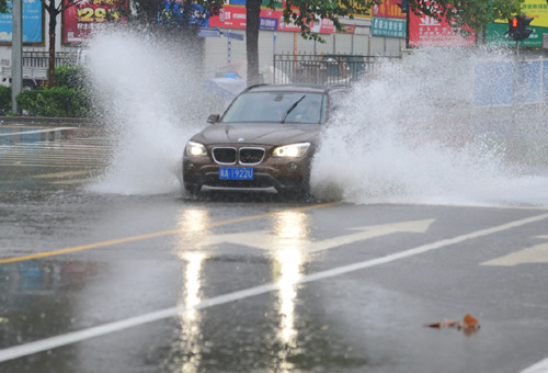 7月20日，車輛在石家莊市談固大街一處積水路段通行。